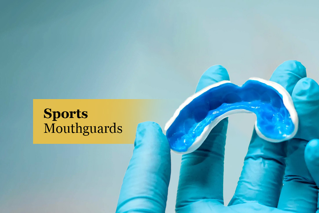 Sports Mouthguards: gloved hand holding a custom blue sports mouthguard